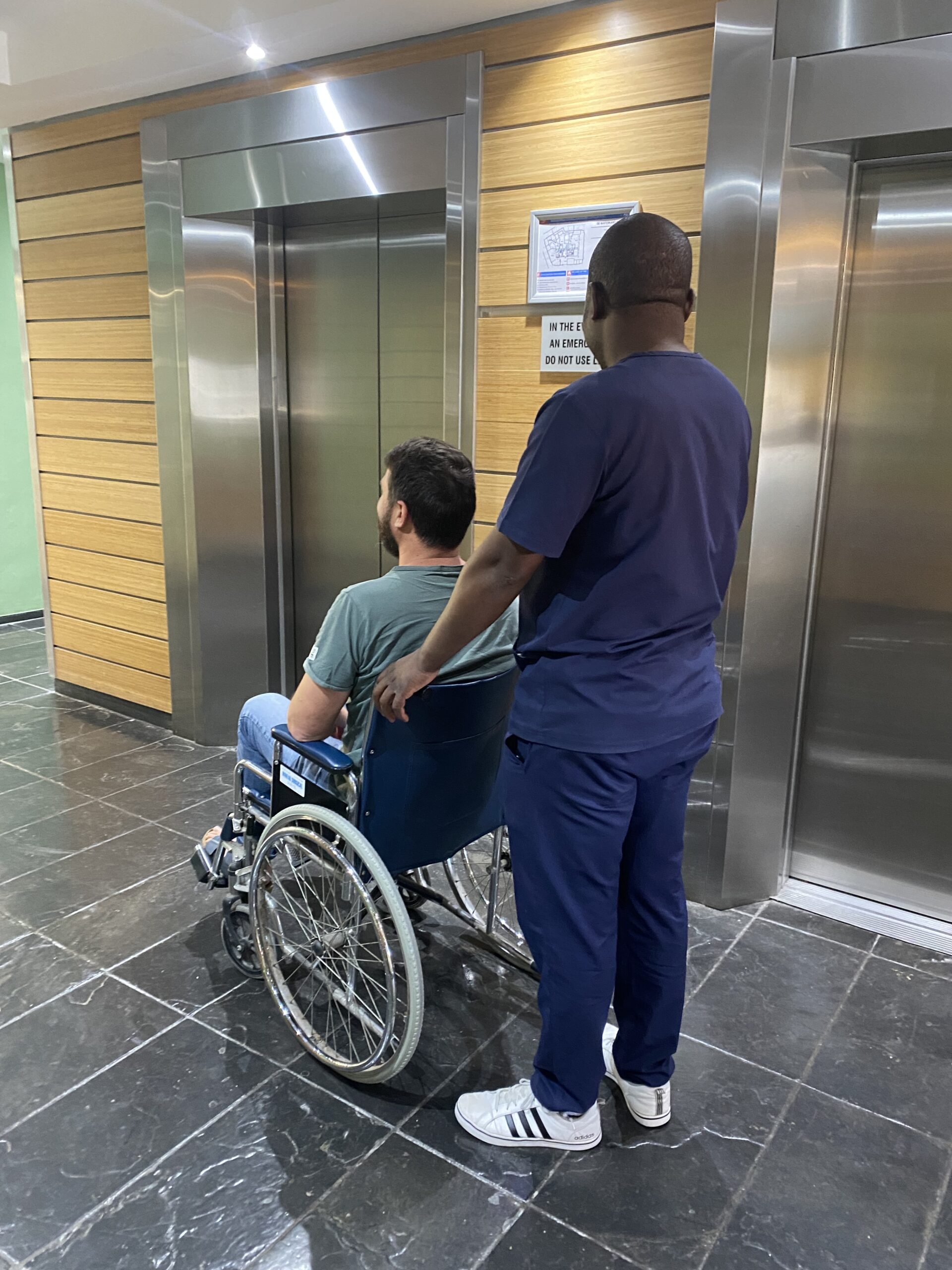 Cape Town dentist Enamel Clinic staff assisting patient in wheelchair