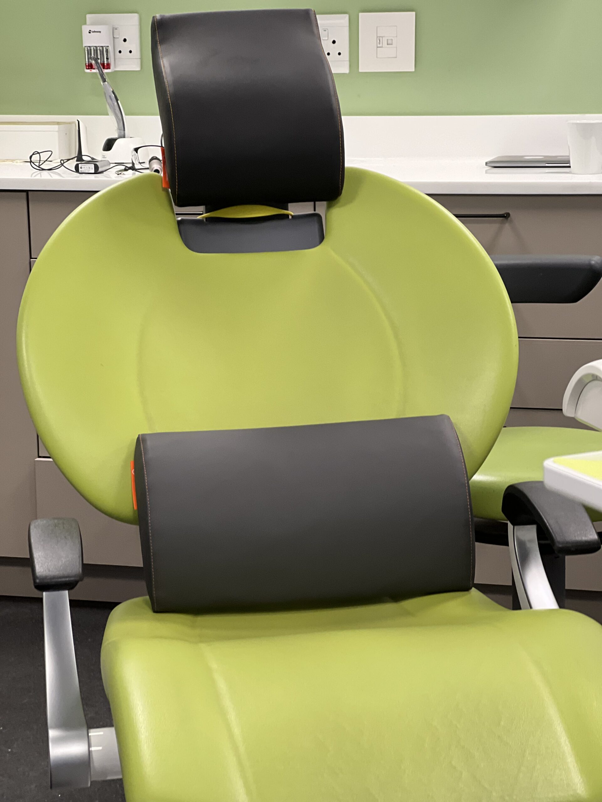 Happynecks neck and lumbar support on patient's chair at Enamel Clinic