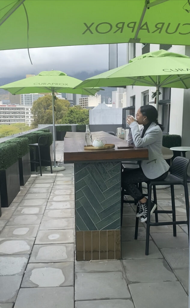 Patient sipping coffee on Enamel Clinic balcony