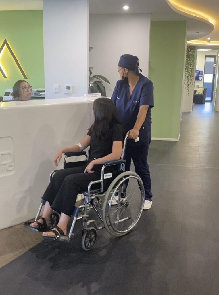 Enamel Clinic staff assisting wheelchair patients